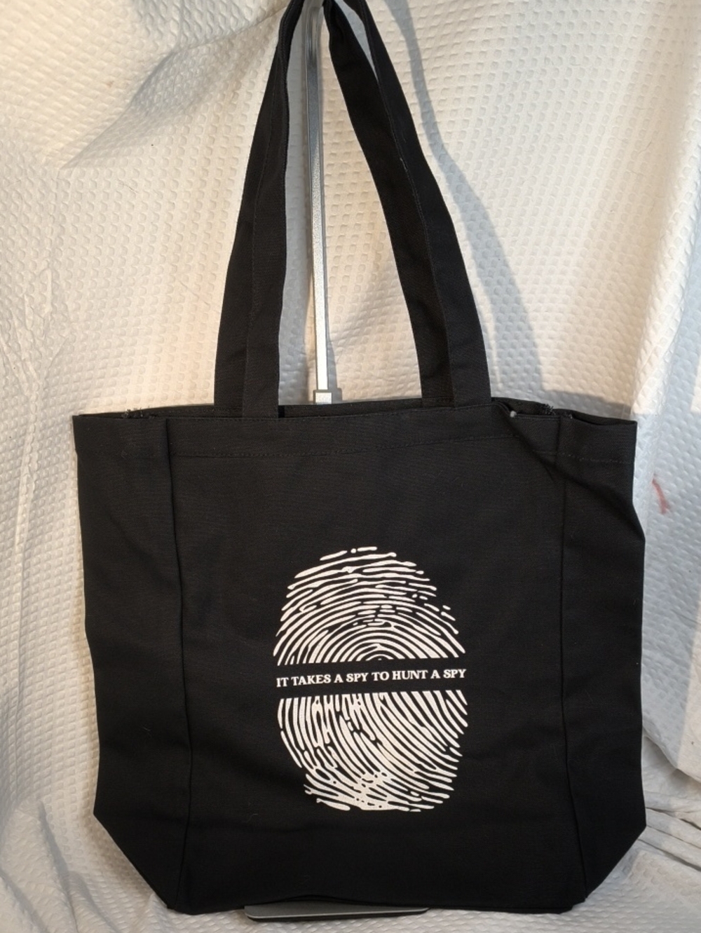 Black Canvas Tote with White Fingerprint Graphic "IT TAKES A SPY TO HUNT A SPY"